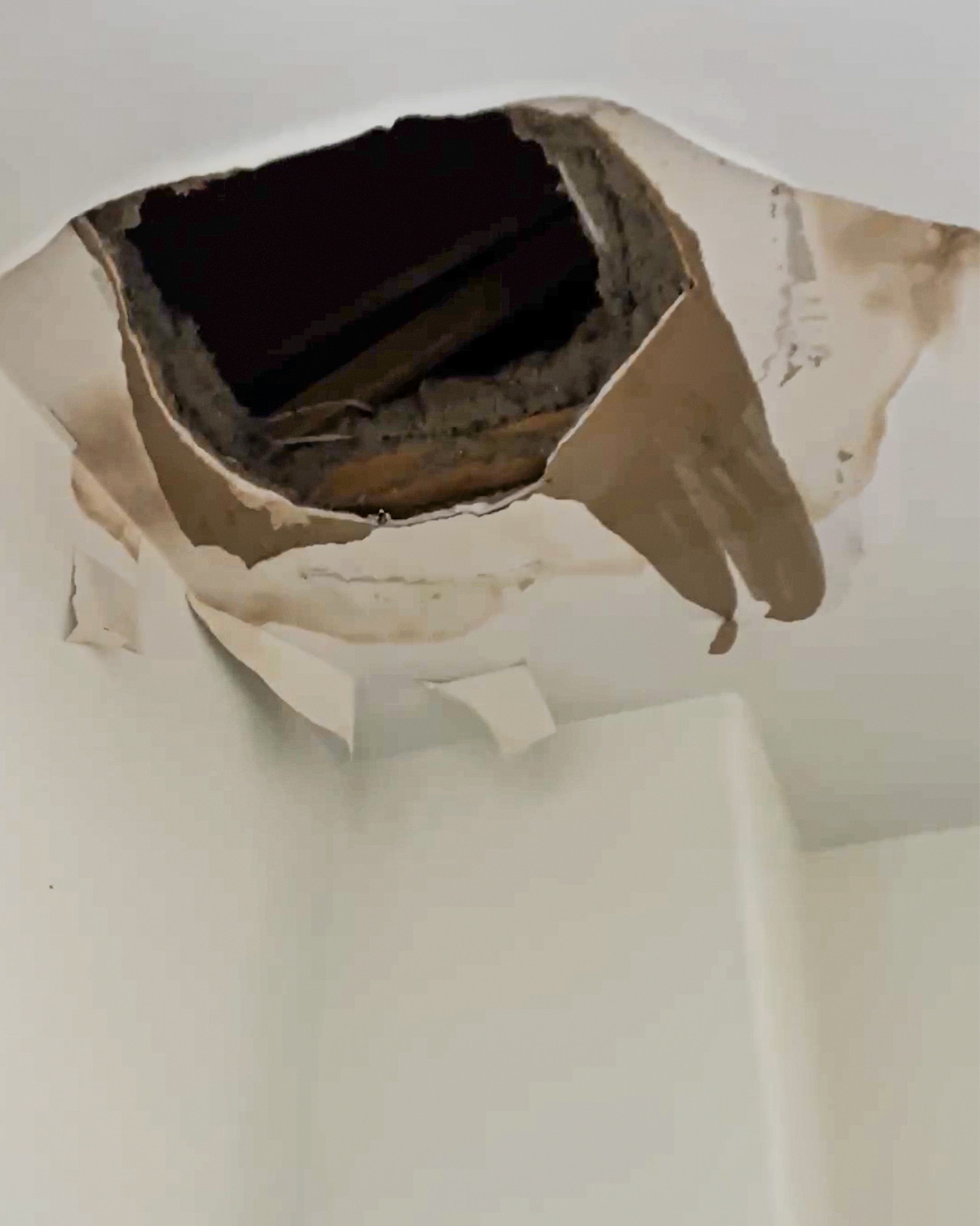 Close view of the documented ceiling damage before repair work.
